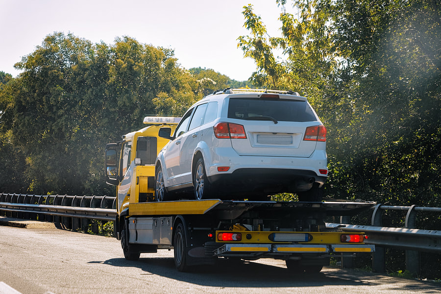 Car being towed from the highway on the back of a tow truck in Georgia.
